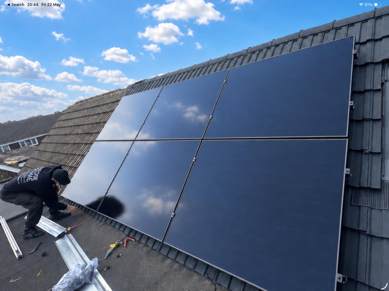 Solar installer fitting panels on a roof
