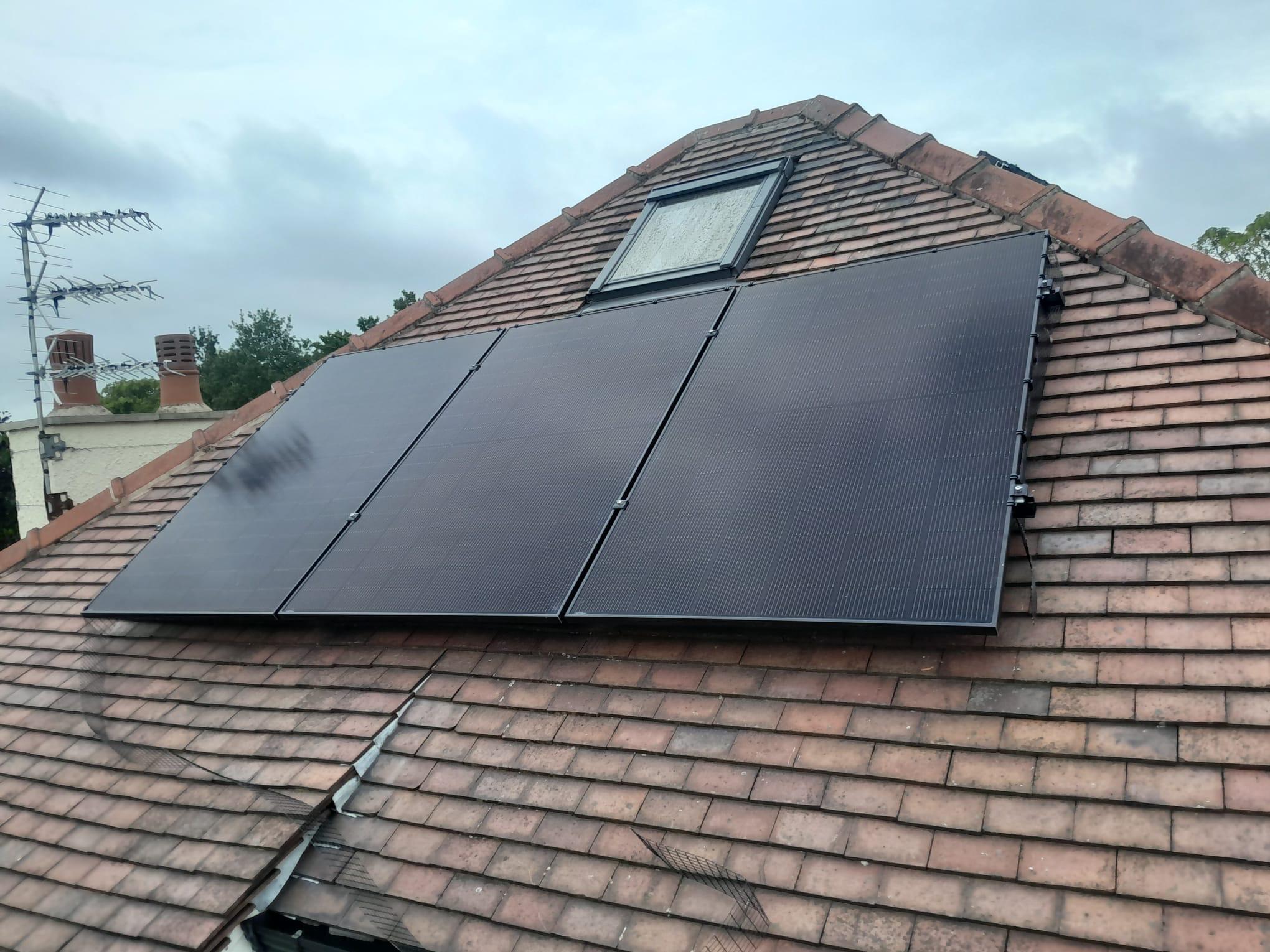 Solar panels installed on a red tiled roof